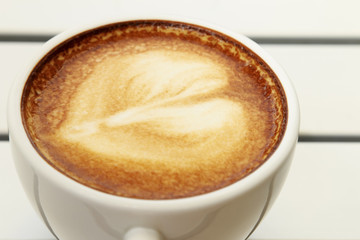 Hot mocha coffee decorated on white background, latte art.