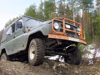 Russian Plain Road in the heart of Siberia. Wheel drive vehicle leaves the swamp © ArtEvent ET