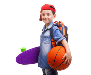 Happy school kid holding a skateboard and a basketball on white © cristovao31