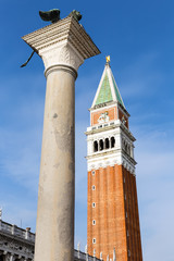 Fototapeta na wymiar Winged St Mark Lion and Campanile (bell tower of St. Mark's Basilica)