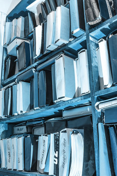 Paper documents stacked on shelf