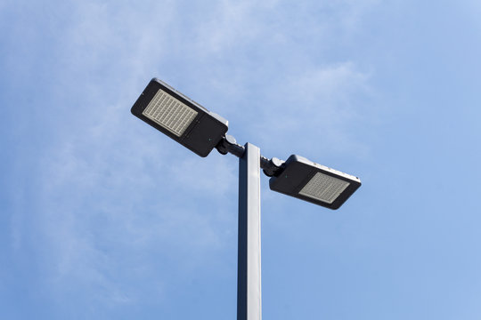 Modern street lighting against blue sky - bottom view - horizontal image