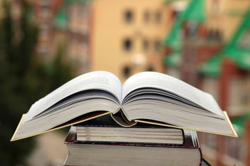 stack of books on city background