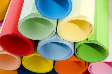 Color paper rolled and piled. Roles of color paper in a stack.
