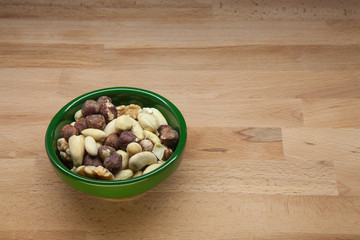 Cup of assorted nuts on a wooden table