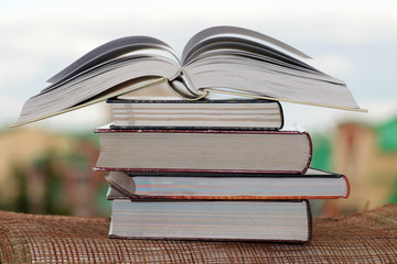 stack of books on city background