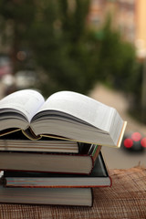 stack of books on city background