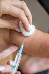 Closeup of female pediatrician vaccinating a baby in his arm wit