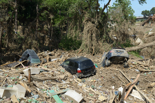 cars lay in  debris after  flood disaster