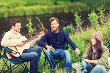 group of tourists playing guitar in camping