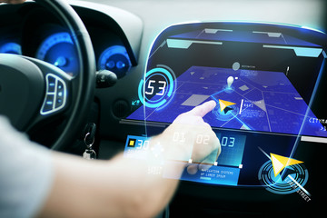 male hand using navigation system on car dashboard