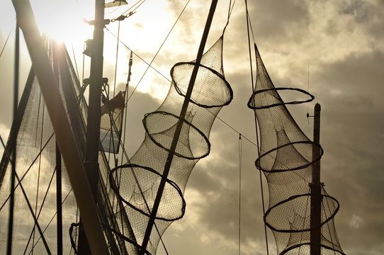 Fishing nets hanged on the mast of a fishing boat