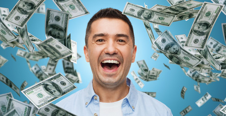 laughing man with falling dollar money