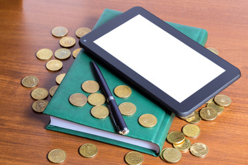 Business still-life - tablet computer, diary, pen and gold coins