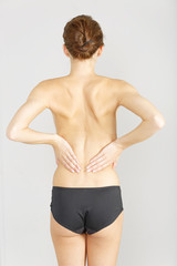 Fototapeta na wymiar Woman with back ache massaging