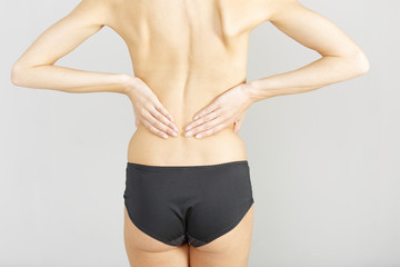 Woman with back ache massaging