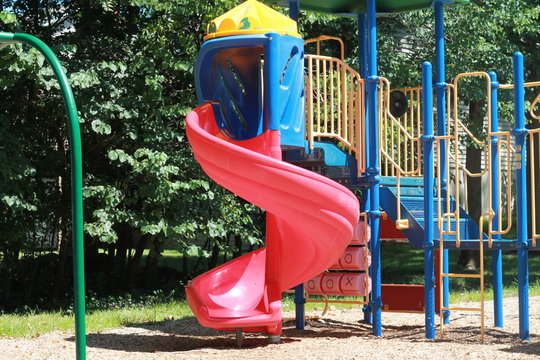 Kids Playground With Mulch And Red Slide