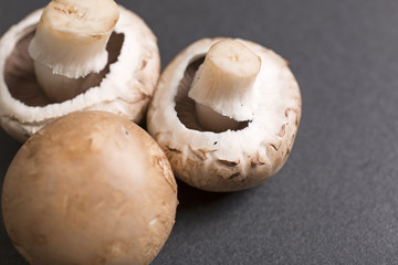 Fresh raw chestnut mushrooms on black slate