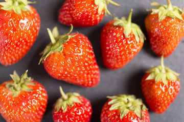 Fresh ripe strawberries on black slate