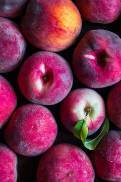 Fresh picked peaches on wooden background