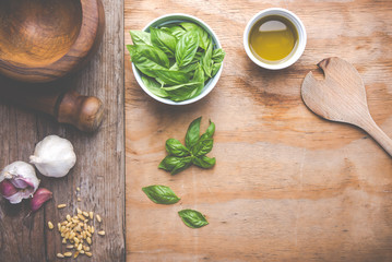 Making pasta with pesto with the original recipe of Genova. Wooden background and accessories communicate the sense of Italy.