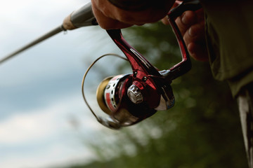 Fisherman with spinning on the water