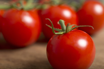 Beautiful fresh cherry tomatoes on a wooden kitchen work surface