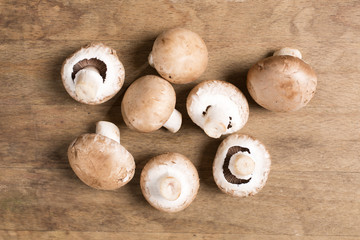 Selection of fresh raw mushrooms on a wooden kitchen work surface