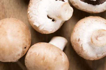 Selection of fresh raw mushrooms on a wooden kitchen work surface