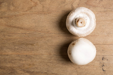 Selection of fresh raw mushrooms on a wooden kitchen work surface