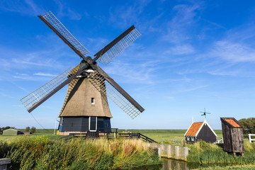 Fototapeta na wymiar A traditional dutch windmill near Hoorn,Netherlands