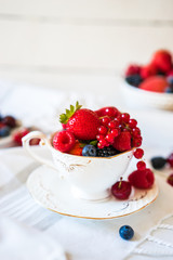 Mix of fresh berries in a cup of tea