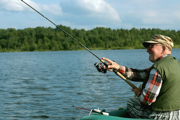 Spinning fisherman on a boat fishing