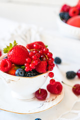 Mix of fresh berries in a cup of tea
