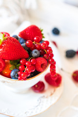 Mix of fresh berries in a cup of tea