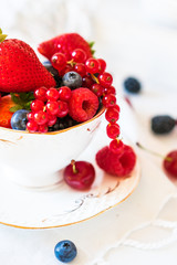 Mix of fresh berries in a cup of tea