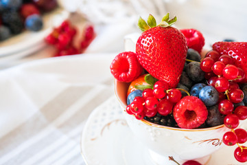 Mix of fresh berries in a cup of tea