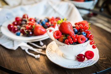 Mix of fresh berries in a cup of tea