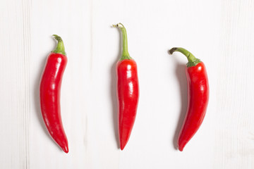Fresh red chilli on a light wooden kitchen work surface