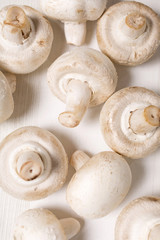 Fresh selection of chestnut mushrooms on a light wooden kitchen surface