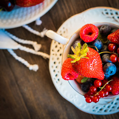 Mix of fresh berries in a cup of tea