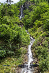 Waterfall in the summer mountains