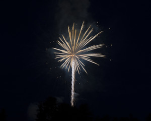 White and orange light streaks from a fireworks long exposure.  