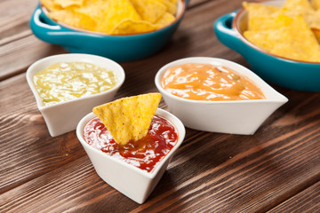 Plate of nachos with different dips