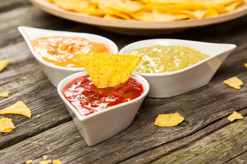 Plate of nachos with different dips