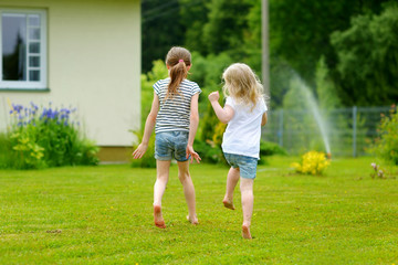 Obraz premium Two adorable little sisters having fun outdoors