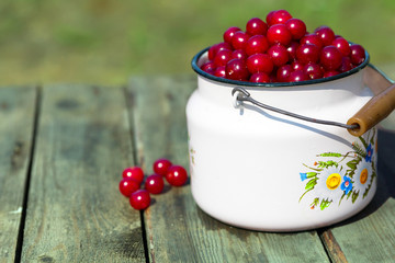 Appetizing red cherry in a white bottle is a close-up