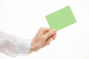Obraz premium Female hand holding a green paper card