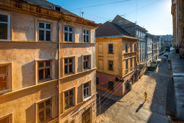 Old city street view with woman walking