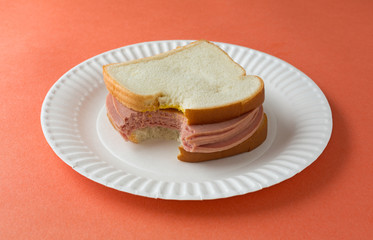 Large bitten bologna sandwich with mustard © Bert Folsom